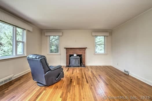 32 Lenox Ave, Norwalk, CT 06854 - unfurnished living room with wood finished floors and baseboards