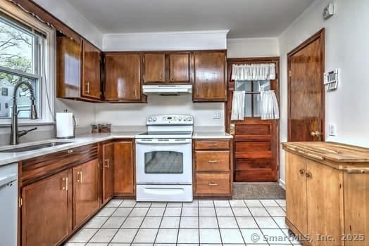32 Lenox Ave, Norwalk, CT 06854 - kitchen featuring white appliances, under cabinet range hood, a sink, and light countertops