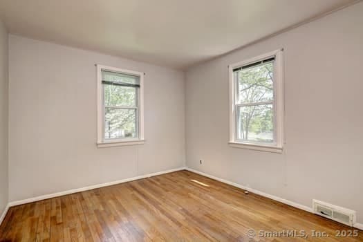 32 Lenox Ave, Norwalk, CT 06854 - unfurnished room with healthy amount of natural light, wood finished floors, and baseboards