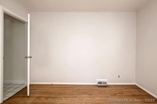 32 Lenox Ave, Norwalk, CT 06854 - unfurnished bedroom with wood finished floors and baseboards