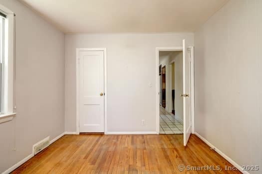 32 Lenox Ave, Norwalk, CT 06854 - unfurnished bedroom with light wood-type flooring and baseboards