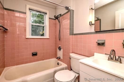 32 Lenox Ave, Norwalk, CT 06854 - full bathroom featuring shower / bathtub combination, toilet, vanity, and tile walls
