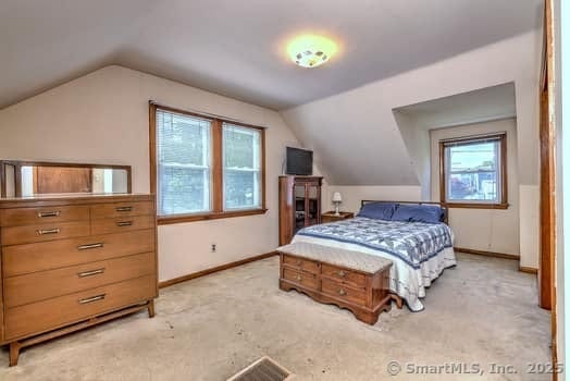32 Lenox Ave, Norwalk, CT 06854 - carpeted bedroom featuring lofted ceiling and baseboards