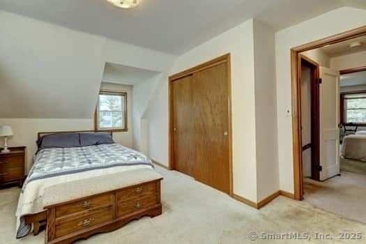 32 Lenox Ave, Norwalk, CT 06854 - bedroom featuring light colored carpet, a closet, lofted ceiling, and baseboards