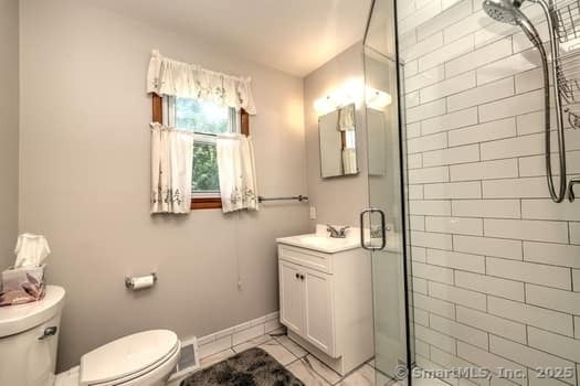 32 Lenox Ave, Norwalk, CT 06854 - full bath featuring toilet, a stall shower, vanity, and tile patterned flooring