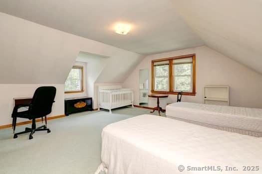32 Lenox Ave, Norwalk, CT 06854 - bedroom with radiator, lofted ceiling, and carpet