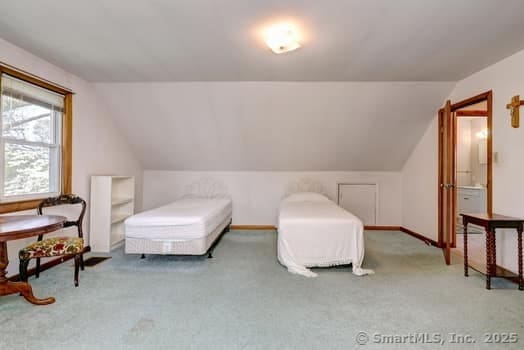 32 Lenox Ave, Norwalk, CT 06854 - carpeted bedroom with vaulted ceiling and baseboards