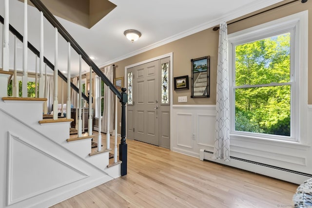 15 Westwood Rd, Essex, CT 06442 - foyer with baseboard heating, ornamental molding, stairs, wainscoting, and wood finished floors