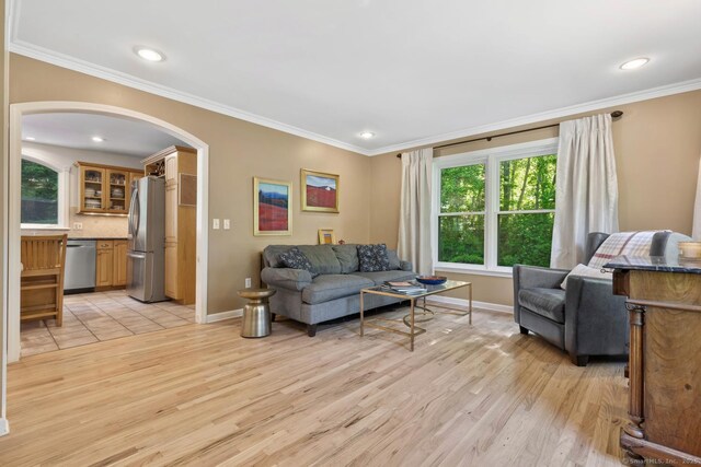 15 Westwood Rd, Essex, CT 06442 - living room with arched walkways, baseboards, light wood finished floors, ornamental molding, and recessed lighting
