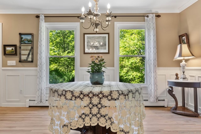 15 Westwood Rd, Essex, CT 06442 - dining space with a chandelier, a baseboard radiator, a decorative wall, healthy amount of natural light, and light wood-type flooring
