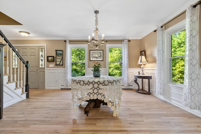 15 Westwood Rd, Essex, CT 06442 - foyer entrance with a chandelier, a decorative wall, stairs, a wainscoted wall, and baseboard heating