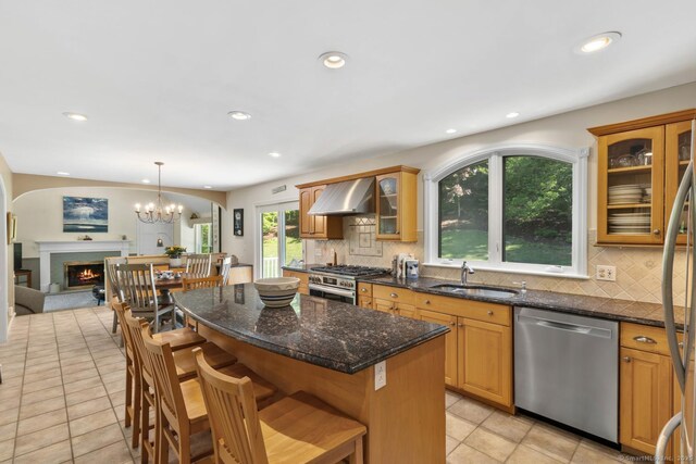 15 Westwood Rd, Essex, CT 06442 - kitchen featuring appliances with stainless steel finishes, a sink, light tile patterned floors, wall chimney exhaust hood, and tasteful backsplash