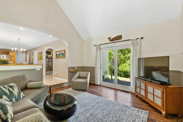 15 Westwood Rd, Essex, CT 06442 - living room with arched walkways, wood finished floors, a wainscoted wall, a chandelier, and high vaulted ceiling