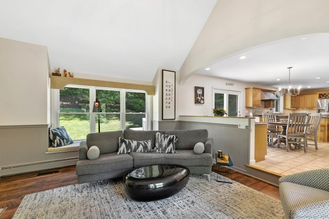 15 Westwood Rd, Essex, CT 06442 - living area featuring a baseboard radiator, a chandelier, arched walkways, recessed lighting, and light wood-style flooring