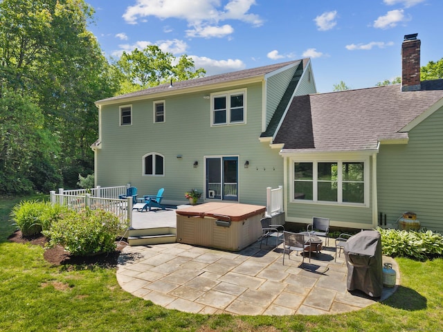 15 Westwood Rd, Essex, CT 06442 - rear view of property with a hot tub, a deck, a patio, a chimney, and roof with shingles