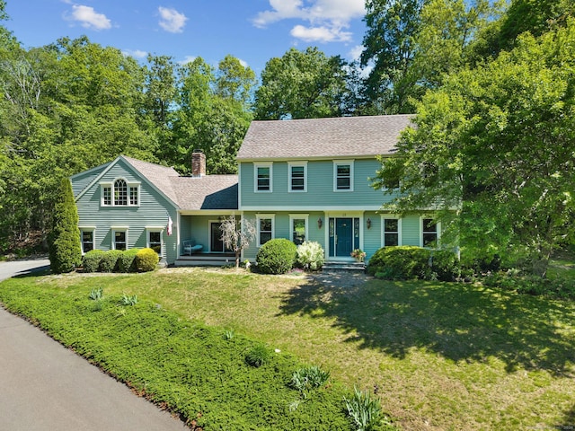 15 Westwood Rd, Essex, CT 06442 - colonial inspired home with a front yard, a chimney, and roof with shingles
