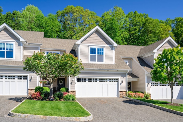 18 Brookside Ct Unit 18, Newtown, CT 06470 - view of front of home featuring stone siding, driveway, roof with shingles, and an attached garage