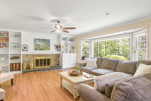 95 Vista Rd, Wilton, CT 06897 - living room with ornamental molding, ceiling fan, light wood finished floors, a fireplace, and built in shelves