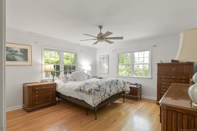95 Vista Rd, Wilton, CT 06897 - bedroom with light wood-type flooring, multiple windows, baseboards, and a ceiling fan