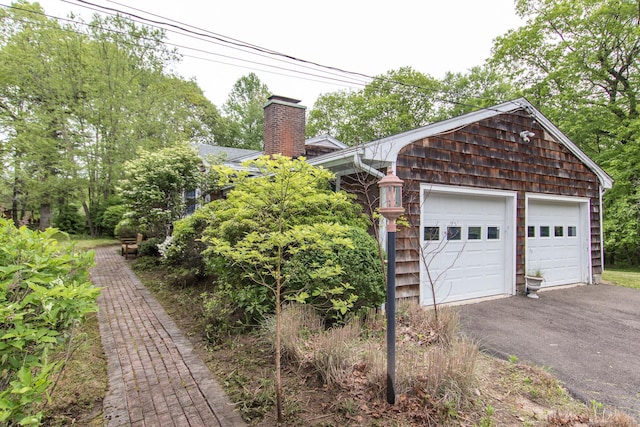 95 Vista Rd, Wilton, CT 06897 - view of side of property with a chimney and a garage