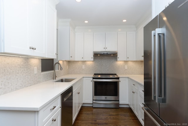 11 Norman Ln, Darien, CT 06820 - kitchen featuring appliances with stainless steel finishes, under cabinet range hood, light countertops, white cabinetry, and recessed lighting
