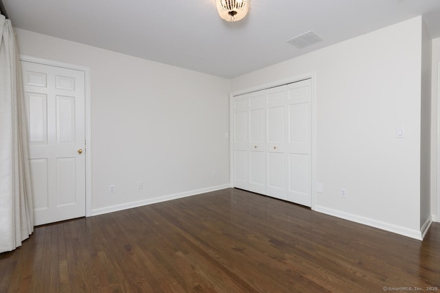 11 Norman Ln, Darien, CT 06820 - unfurnished bedroom with dark wood-style flooring and a closet