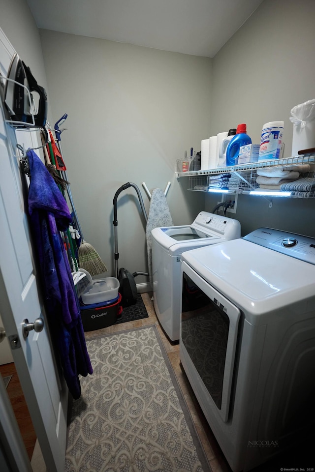 laundry room with separate washer and dryer and wood finished floors