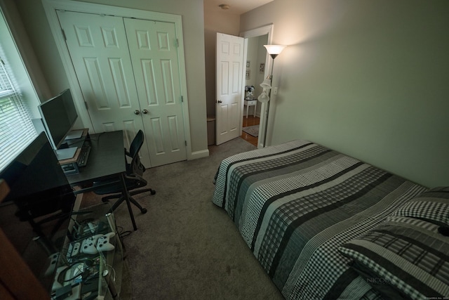 carpeted bedroom featuring a closet and a desk