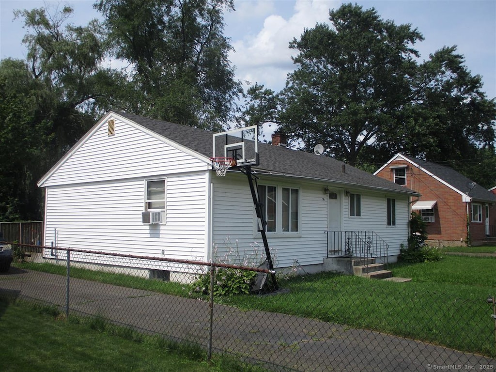 view of property exterior featuring cooling unit, a chimney, and a shingled roof