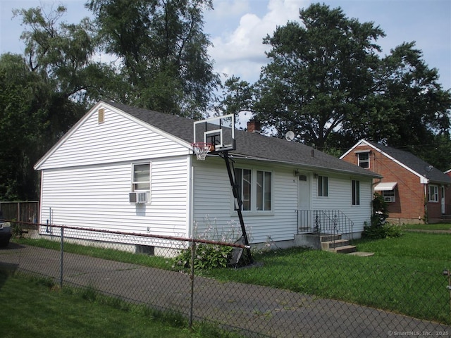 view of property exterior featuring cooling unit, a chimney, and a shingled roof