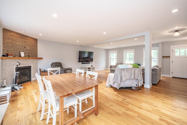 917 N Grand St, Suffield, CT 06093 - dining room with recessed lighting, plenty of natural light, light wood-style flooring, a glass covered fireplace, and baseboards