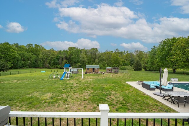 917 N Grand St, Suffield, CT 06093 - view of yard with a playground, a patio area, an outdoor living space with a fire pit, and a forest view