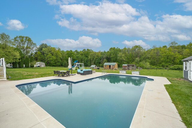 917 N Grand St, Suffield, CT 06093 - outdoor pool with a storage unit, a lawn, an outbuilding, a playground, and a patio