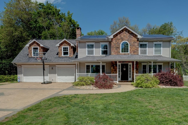 view of front of house featuring covered porch, driveway, a chimney, a garage, and a front yard