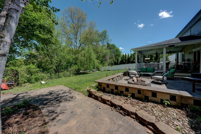 view of yard featuring a patio area and an outdoor living space with a fire pit