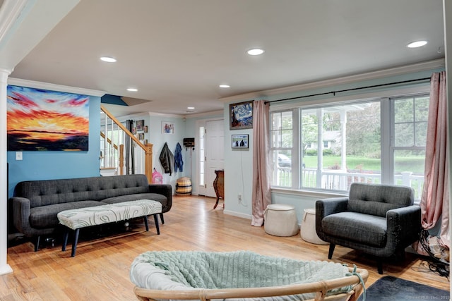 living room featuring crown molding, stairway, light wood-type flooring, and recessed lighting