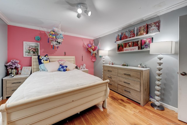 bedroom with ornamental molding and light wood finished floors