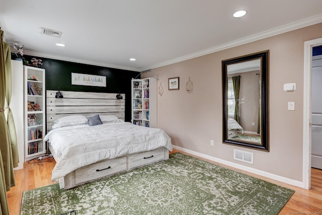 bedroom featuring wood finished floors, ornamental molding, baseboards, and recessed lighting