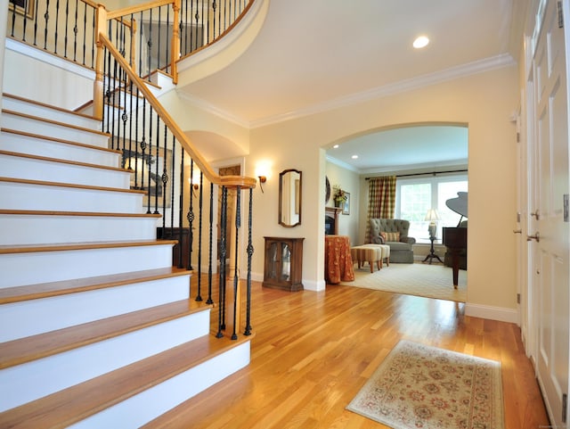 21 Pheasant Hill Rd, Canton, CT 06019 - entryway featuring arched walkways, crown molding, baseboards, wood finished floors, and stairs