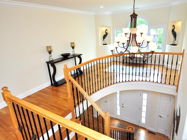 21 Pheasant Hill Rd, Canton, CT 06019 - stairway featuring a chandelier, plenty of natural light, wood finished floors, baseboards, and ornamental molding