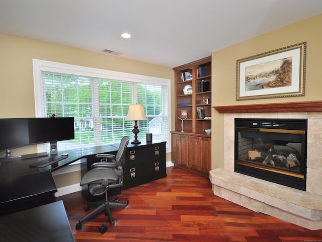 21 Pheasant Hill Rd, Canton, CT 06019 - home office with dark wood-style flooring, a tile fireplace, baseboards, recessed lighting, and built in shelves