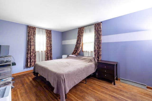 28 Bingham St, Bristol, CT 06010 - bedroom with a baseboard heating unit, wood finished floors, and baseboards