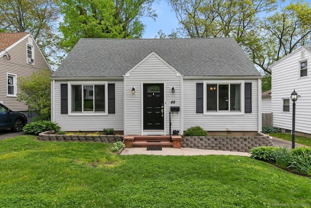 49 Hillside Ave, West Haven, CT 06516 - view of front facade featuring a front lawn and a shingled roof