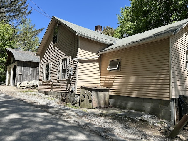 16 River Pl, Norfolk, CT 06058 - view of side of property with a chimney and an outdoor structure