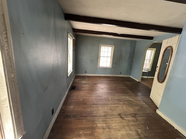 16 River Pl, Norfolk, CT 06058 - empty room featuring arched walkways, beam ceiling, wood-type flooring, and baseboards
