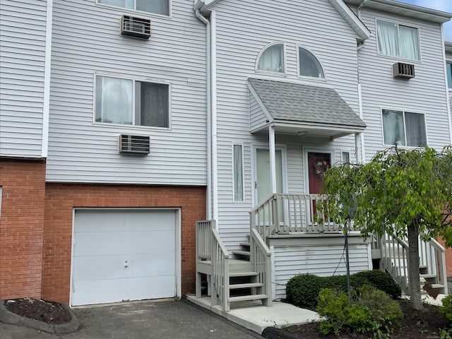 925 Oronoke Rd Unit 15C, Waterbury, CT 06708 - view of front of home featuring an attached garage, brick siding, and an AC wall unit