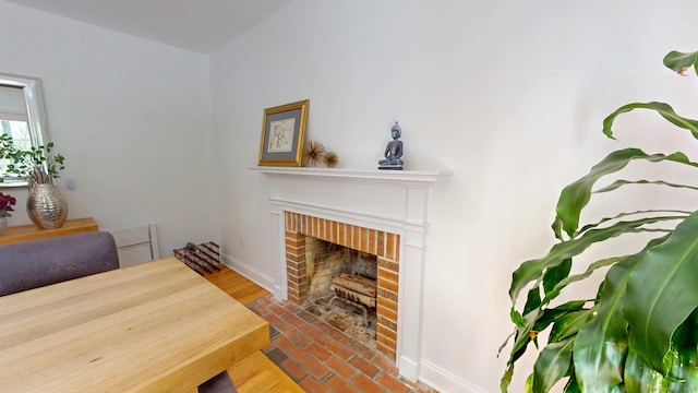 living room with baseboards and a brick fireplace