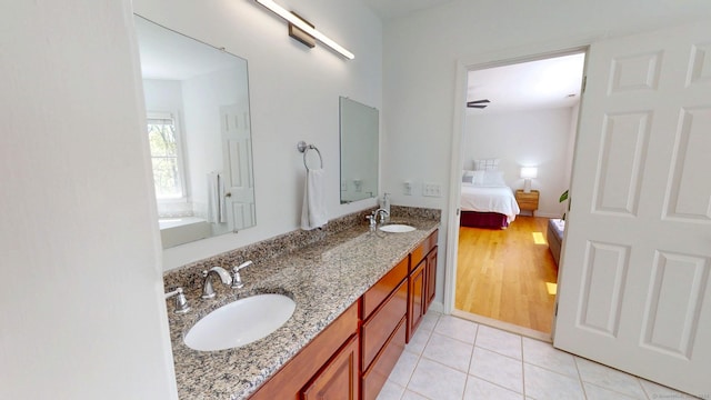 full bathroom featuring ensuite bath, tile patterned flooring, and double vanity
