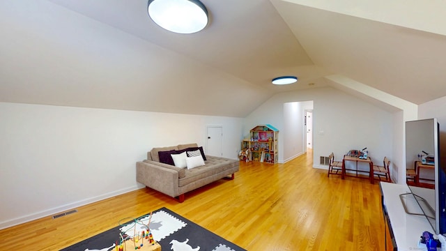 bonus room featuring wood finished floors, vaulted ceiling, and baseboards