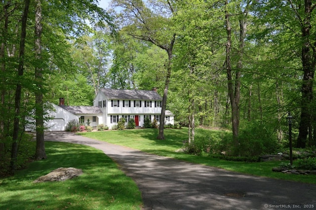 7 Indian Trl, Woodbridge, CT 06525 - colonial-style house with a chimney, an attached garage, driveway, and a front yard